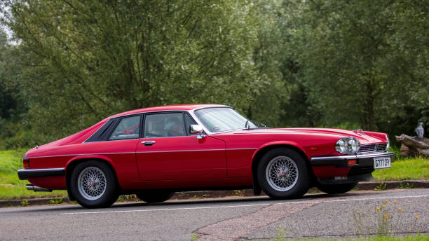 Stony Stratford, Bucks, UK Aug 29th 2021. 1989 red JAGUAR XJS   classic car travelling on an English country road